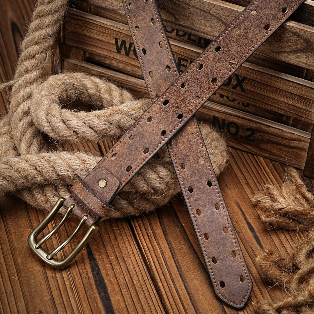 Close-up of a men's rugged distressed leather belt in brown, showcasing its unique perforated design texture.