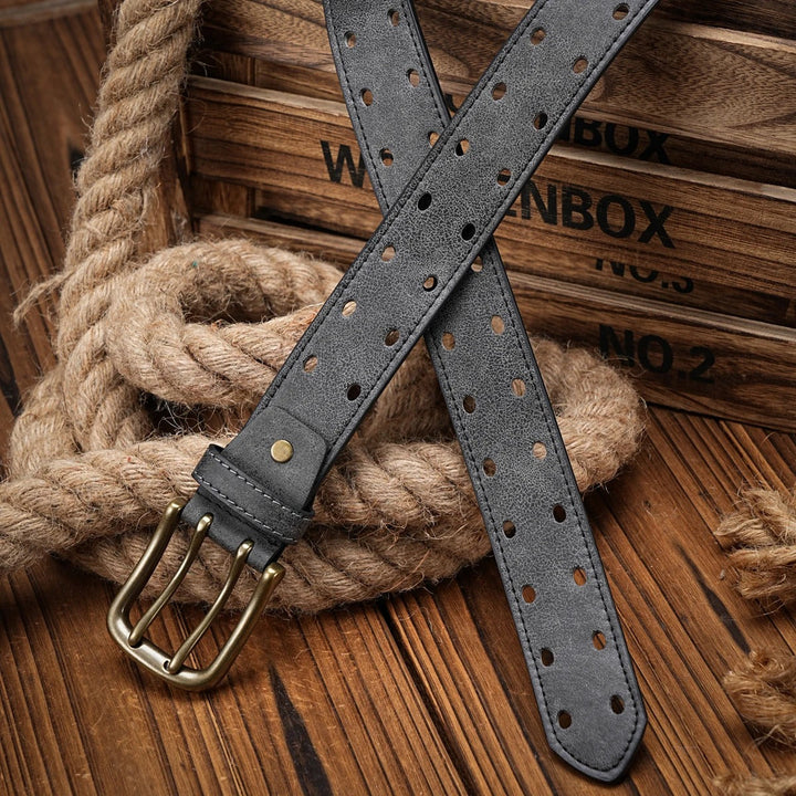Full length view of a men's distressed dark brown leather belt, highlighting its perforated and rugged details.