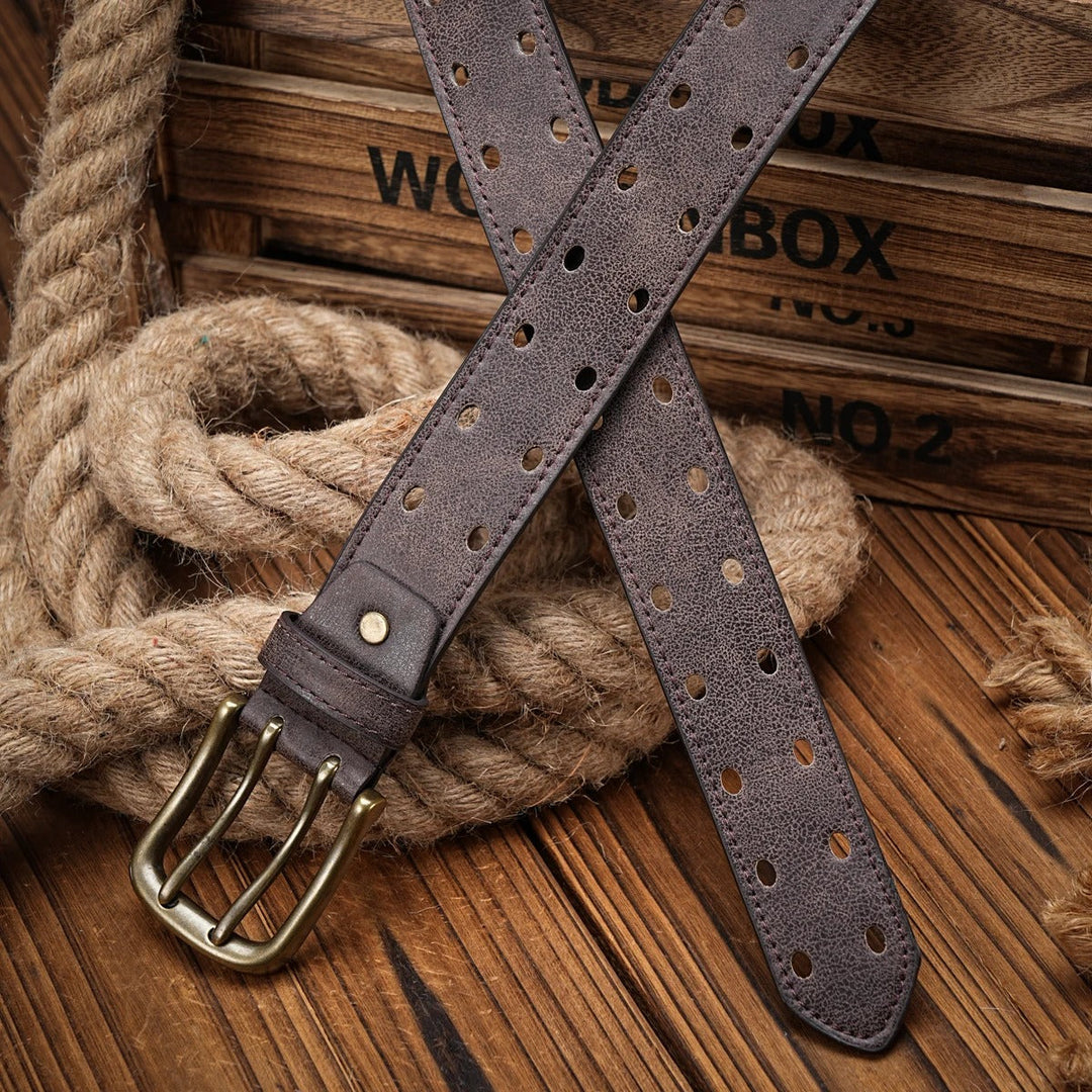 Zoomed in detail of a black men's distressed leather belt, emphasizing the quality and perforated design.
