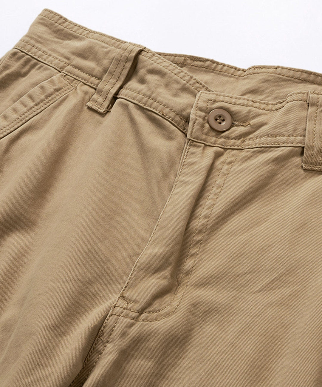 Detail shot of the button and zipper closure on men's dark blue cotton cargo shorts.