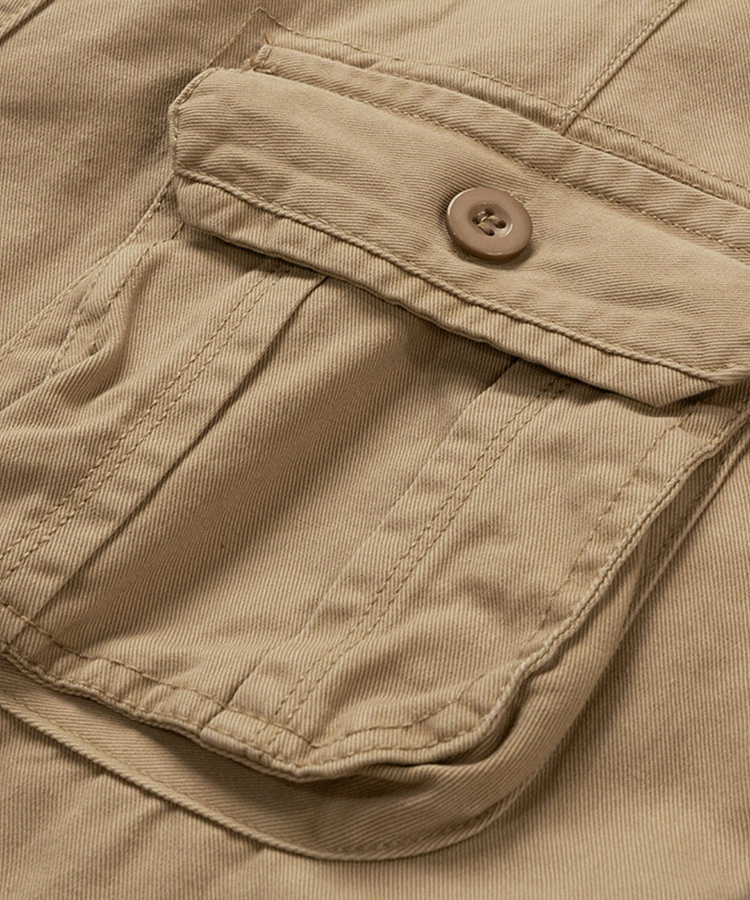 Model demonstrating the comfortable fit of men's beige cotton cargo shorts.