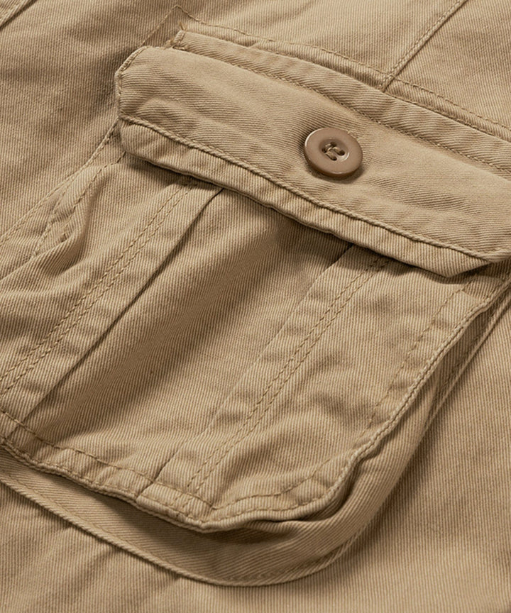 Model demonstrating the comfortable fit of men's beige cotton cargo shorts.