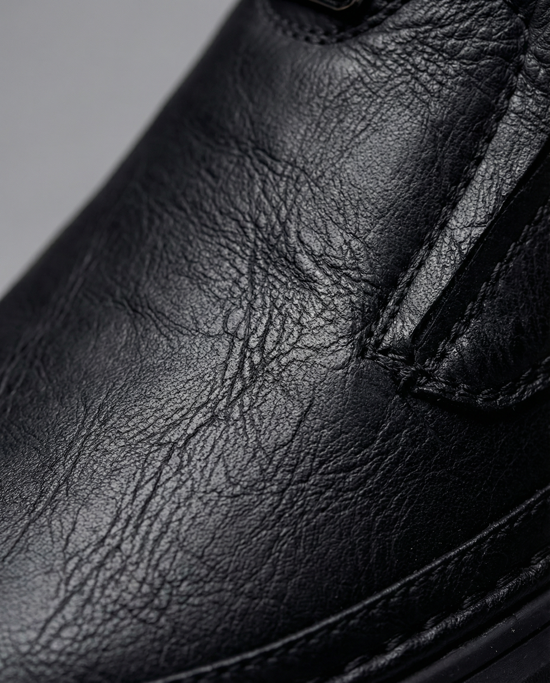 Pair of black men's slip-on leather shoes on a white background, comfortable
