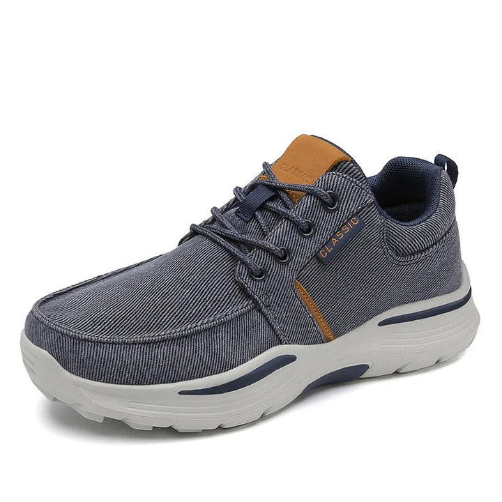 Back view of men's blue canvas comfort sneakers, showing branded heel tab and comfortable design.