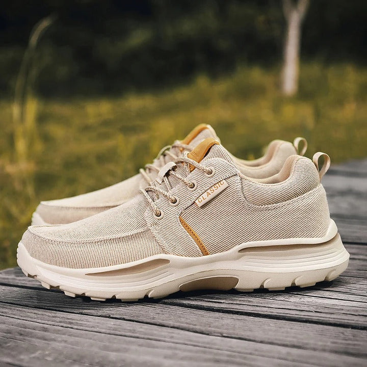 Close-up of the canvas texture on men's khaki comfort sneakers, highlighting breathable fabric.