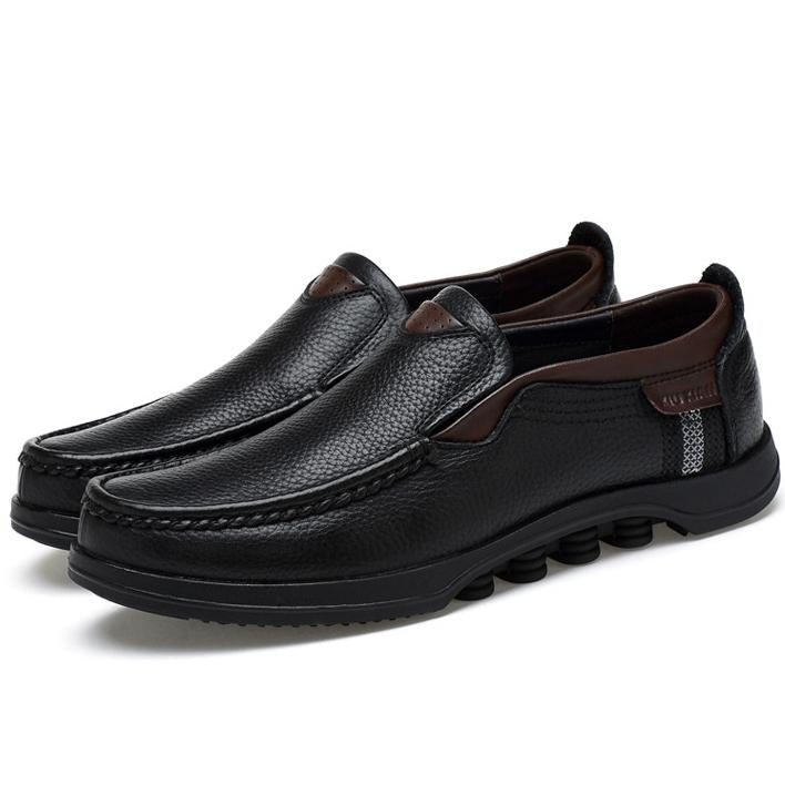 Modern men's faux leather slip-on loafers in a sleek, minimalist style.