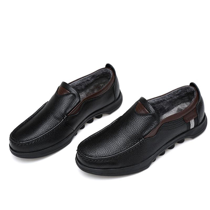 Men's black faux leather slip-on loafers on a white background, studio shot.