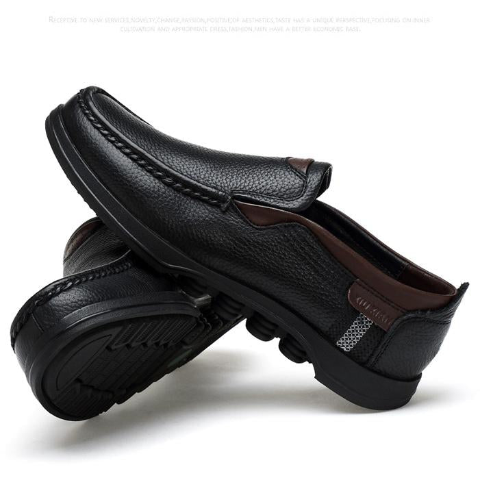 Men's faux leather slip-on loafers, showcasing the flexible construction.