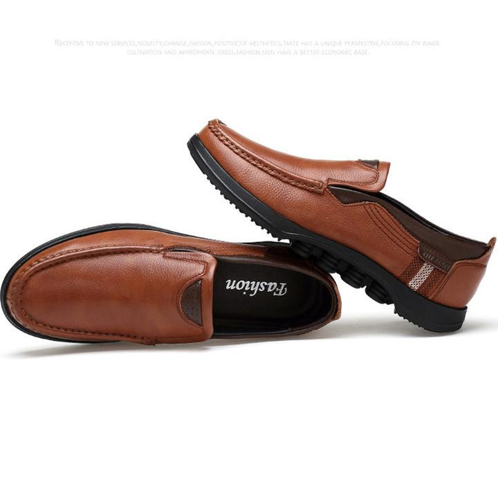Close-up of the textured faux leather on men's slip-on casual loafers.