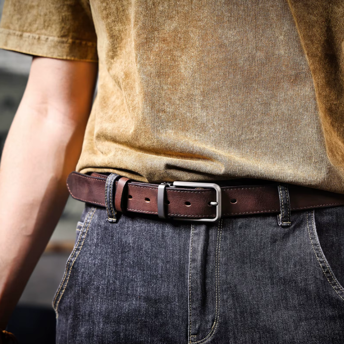 Men's full-grain brown leather belt with a brushed metal buckle, rugged casual style
