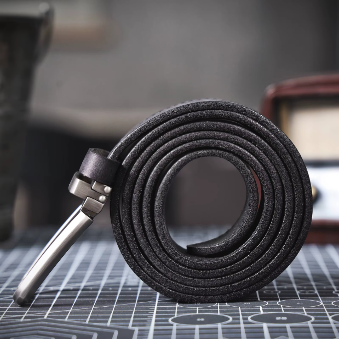 Detailed shot of a men's full-grain leather belt, emphasizing natural grain and quality