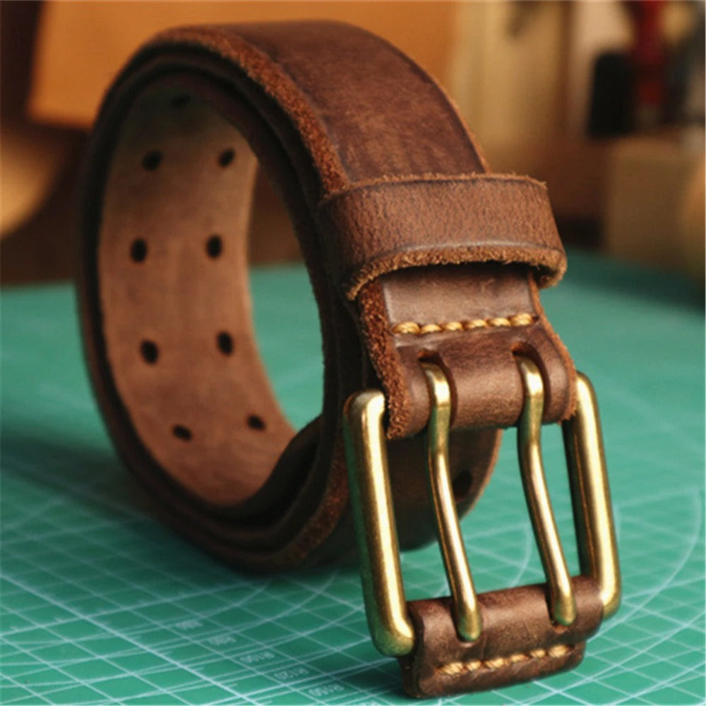 Light brown full-grain leather belt, a rugged men's accessory with a sturdy double-prong buckle.
