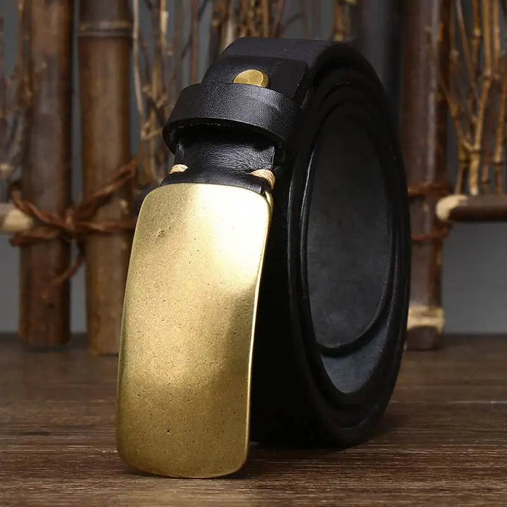 Handcrafted men's belt from full grain cowhide leather with a classic forged brass buckle. Vintage aesthetic.