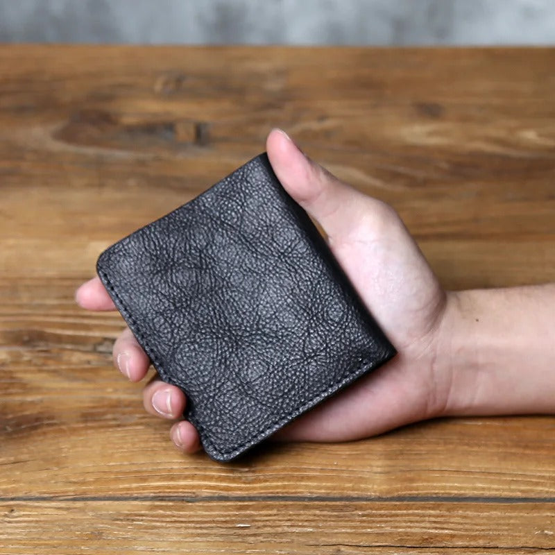 Front view of a minimalist men's full-grain leather bi-fold wallet, designed for durability.
