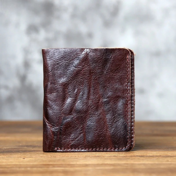 Slim men's full-grain leather bi-fold wallet in black, perfect for everyday carry and front pocket.