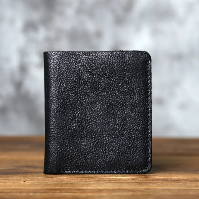 Close-up of a men's full-grain leather bi-fold wallet, highlighting the natural texture and patina potential.