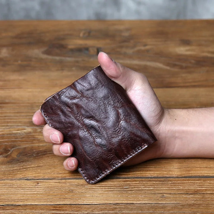 Men's leather bi-fold wallet in a dark tan, full-grain, durable and designed for daily use.