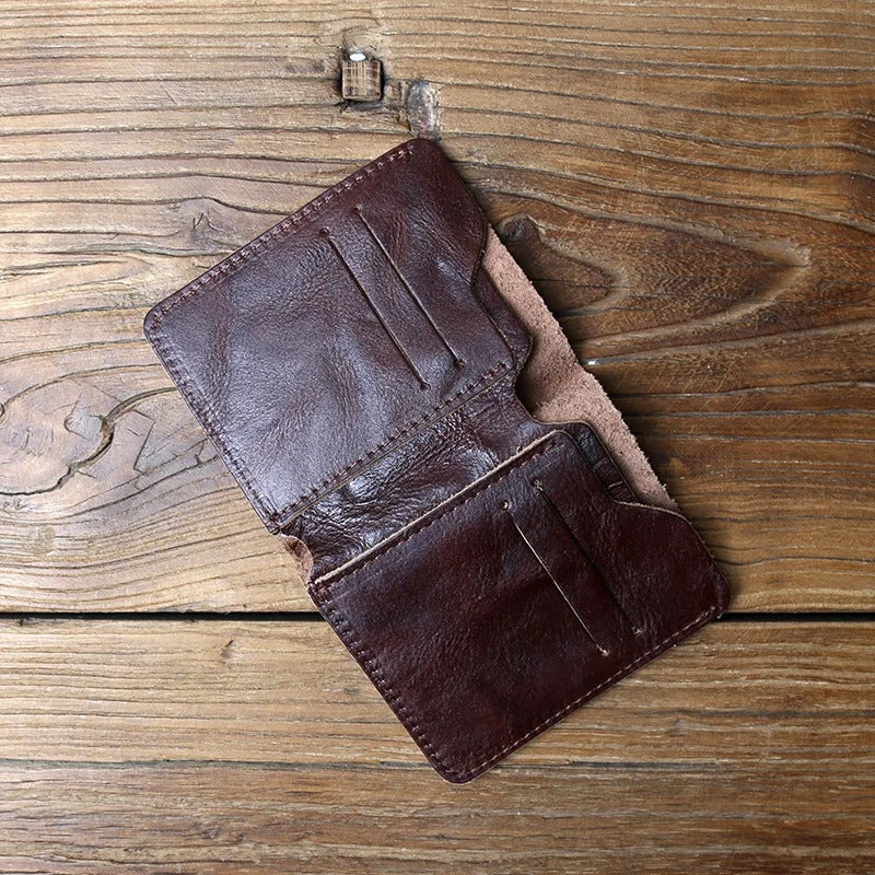 Stacked men's full-grain leather bi-fold wallets in various colors, showcasing accessory collection.