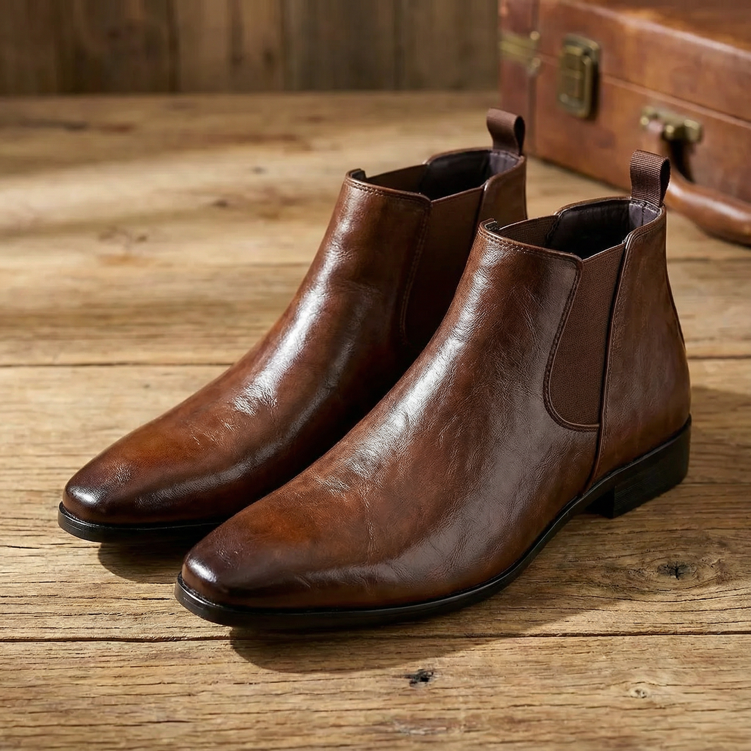 Classic black full-grain leather Chelsea boots for men, close-up of ankle elastic, versatile footwear