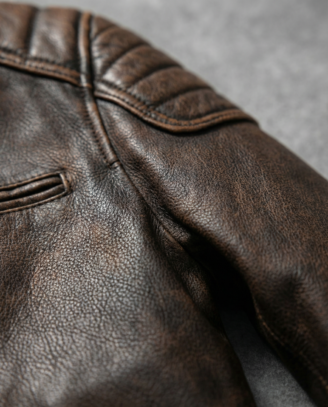 Back view of a mens full-grain leather rider jacket, displaying its sleek and rugged design.