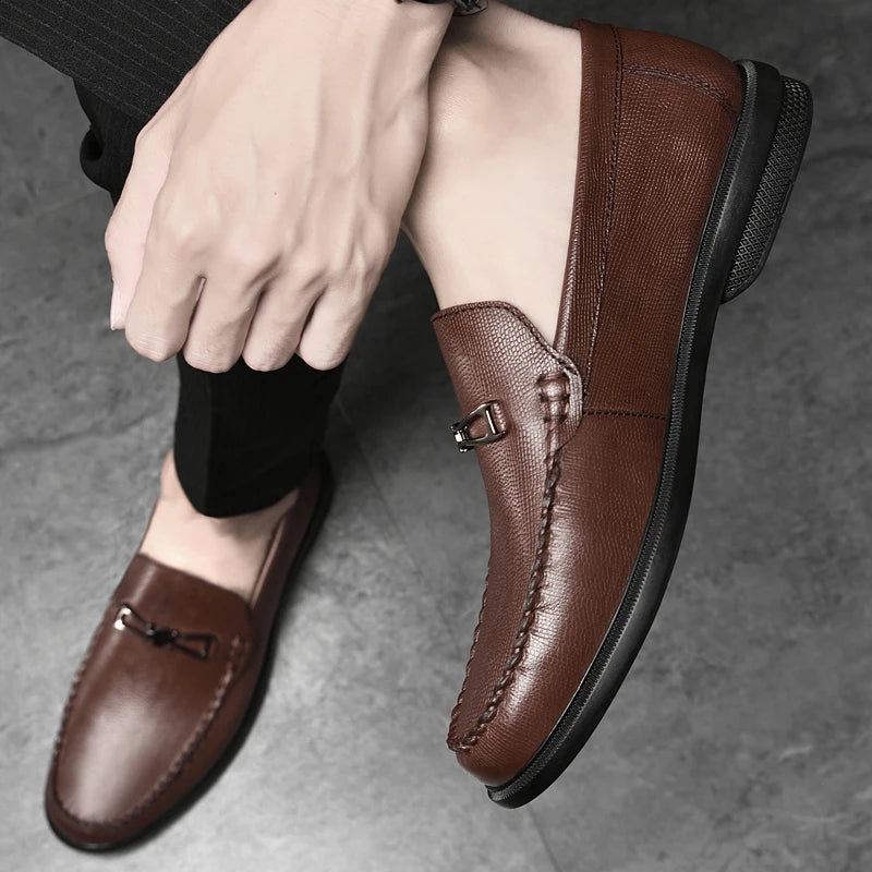 Side view of a men's genuine leather loafer, detailing the smooth finish and metal hardware.