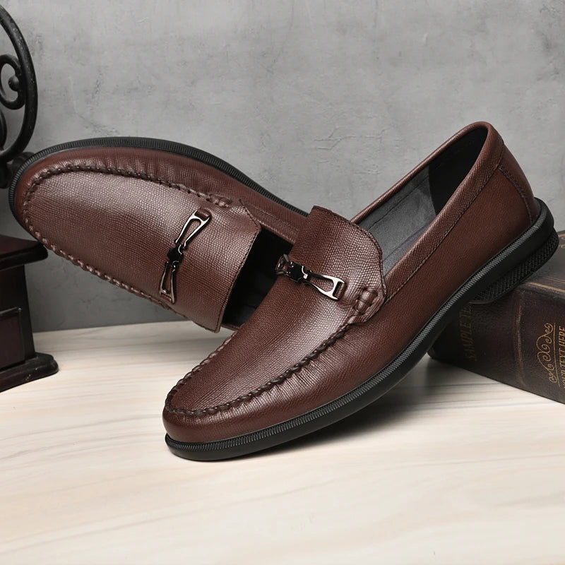 Durable men's slip-on leather loafers, showcasing the quality craftsmanship and elegant metal detail.