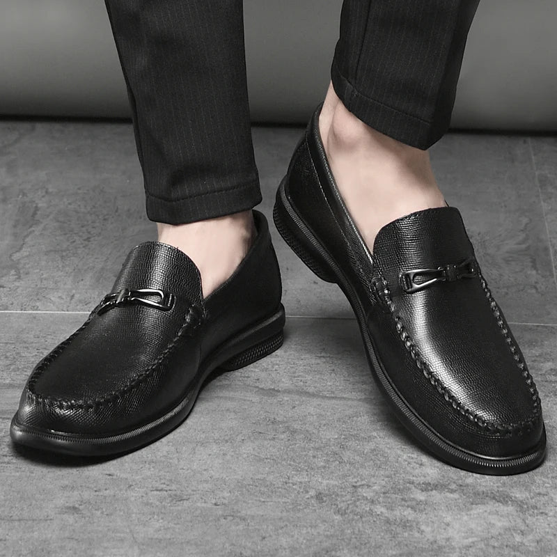 High-angle shot of men's black leather loafers, versatile for dress or casual wear.