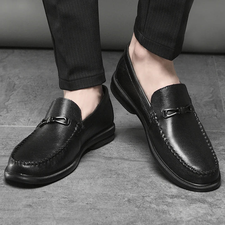 High-angle shot of men's black leather loafers, versatile for dress or casual wear.