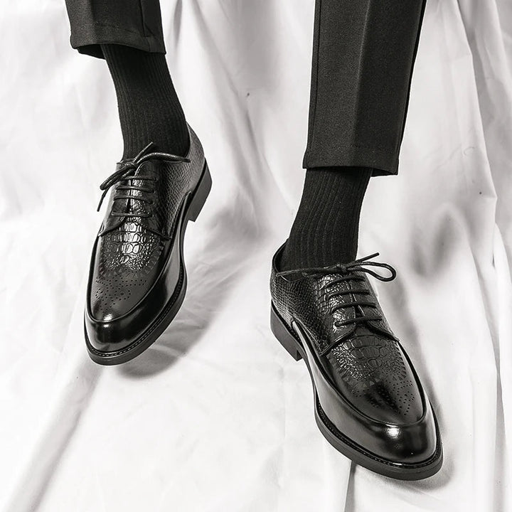 Stack of men's genuine leather Oxford shoes in various colors, highlighting range of formal footwear.