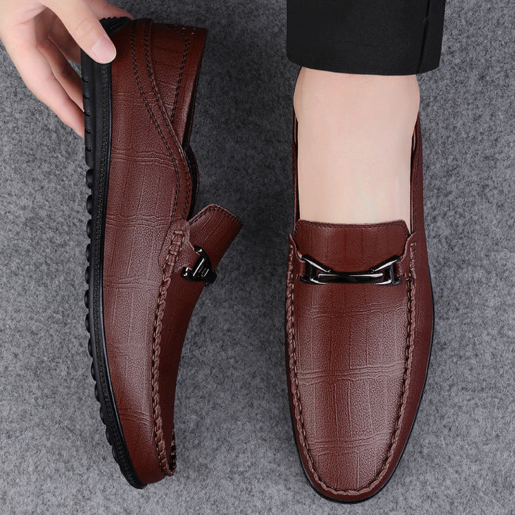 Men's genuine leather slip-on loafers displayed with a suit, perfect for formal attire