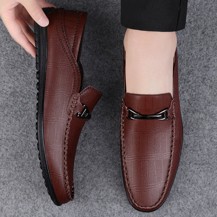 Men's genuine leather slip-on loafers displayed with a suit, perfect for formal attire