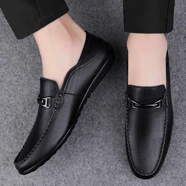 Close-up of men's genuine leather slip-on loafers, detailed stitching and rich texture
