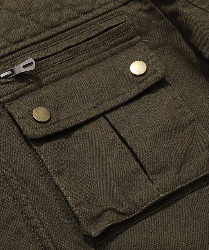 Detail of the robust zipper and snap closures on a men's quilted field jacket.