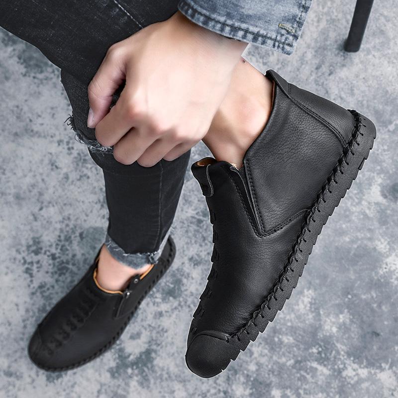 Back view of men's hand-stitched brown leather ankle boot, showing heel design