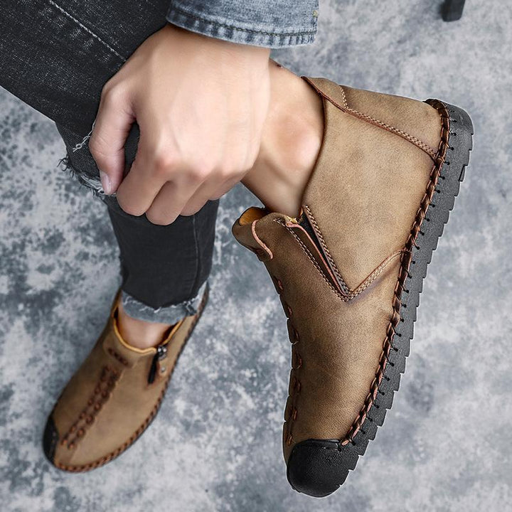 Side view of men's hand-stitched leather ankle boot, emphasizing durable construction