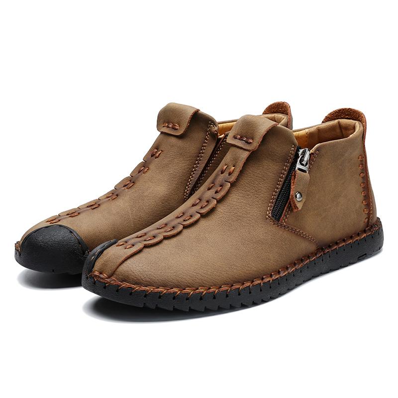 Detail of brown leather texture and hand-stitching on men's casual ankle boot