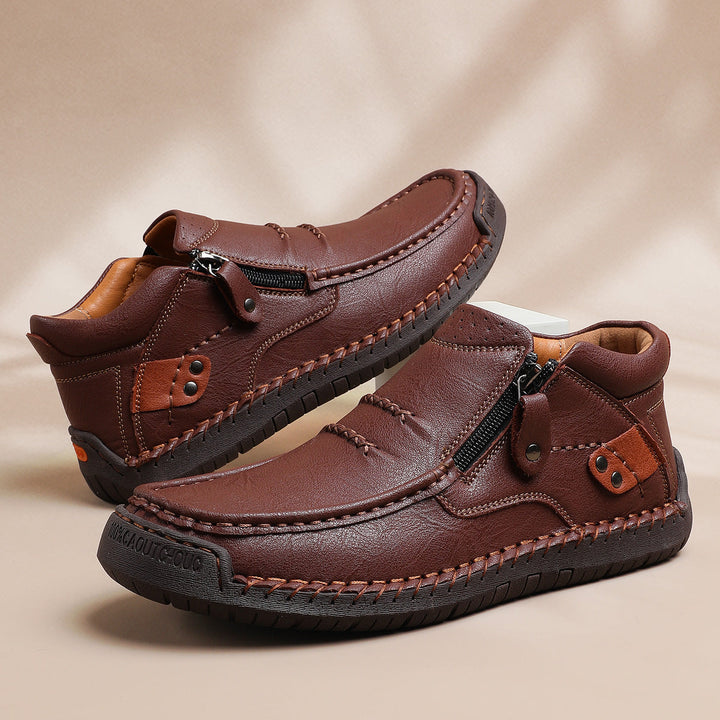 Pair of comfortable men's high-top leather ankle boots, showcasing the rich, durable leather texture.