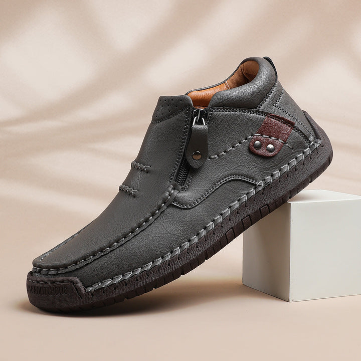 Men's high-top leather boots with a robust sole, highlighting the hand-stitched detail and quality.