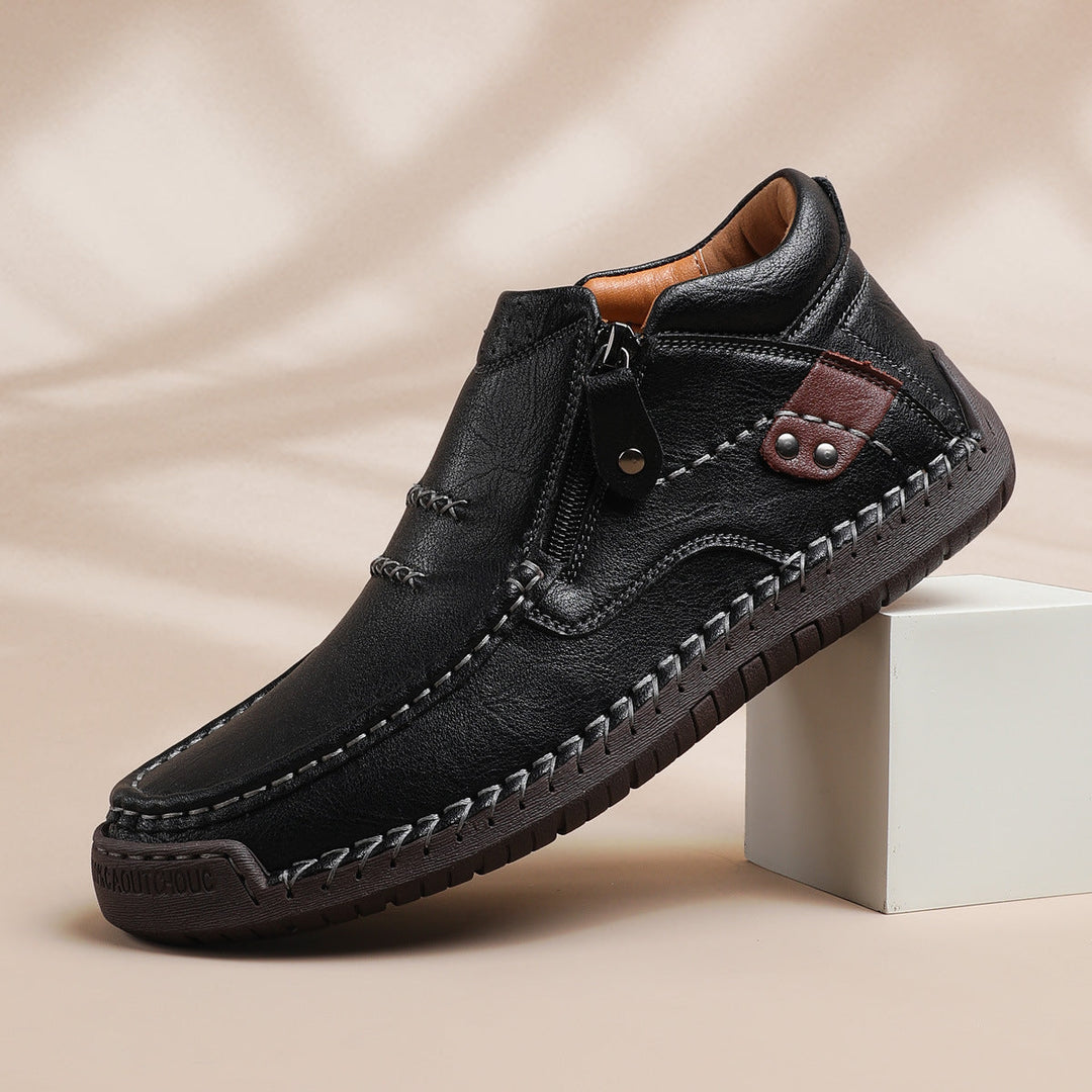 Stylish men's hand-stitched high-top brown leather boots, versatile for both casual and dress wear.