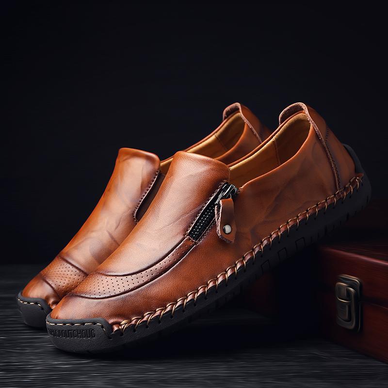 Side profile of men's leather slip-on loafers, hand-stitched detail, modern zipper feature