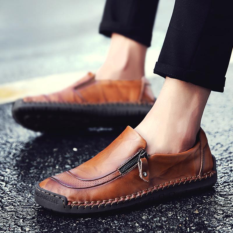 Close-up of men's leather slip-on loafers, detailed hand-stitching & functional zipper