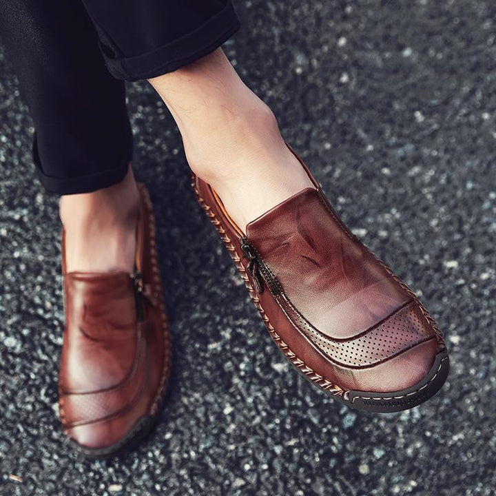 Classic men's tan leather slip-on loafers, hand-stitched details, convenient zipper closure