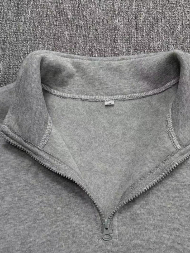 Detail of the fleece fabric on a men's stylish half-zip sweatshirt, emphasizing warmth and comfort