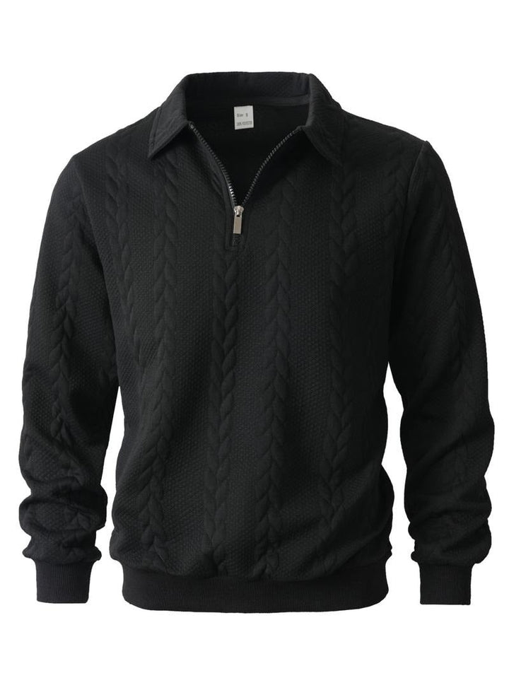 Stylish man wearing a black half-zip knit pullover sweater with a collared shirt for a layered look.