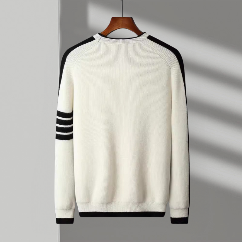 Close-up of the soft knit fabric and contrasting stripe detail on a men's crewneck sweater.