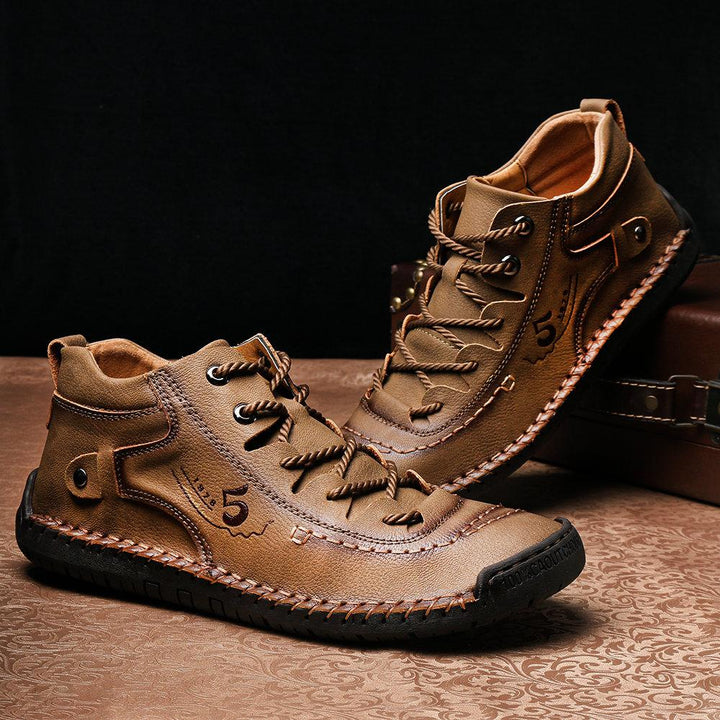 Side profile of men's cowhide high-top leather boots, hand-stitched, emphasizing footwear detail