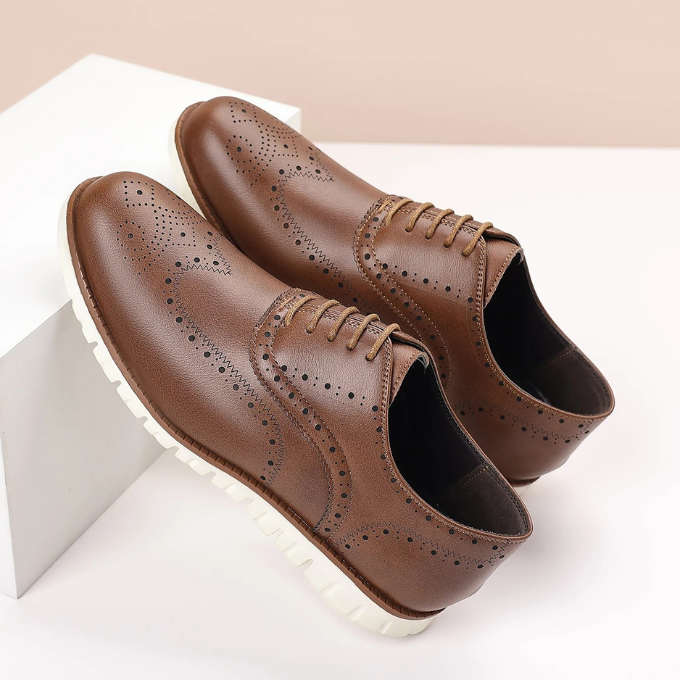 Close-up of the intricate brogue detailing on a men's stylish hybrid dress sneaker.
