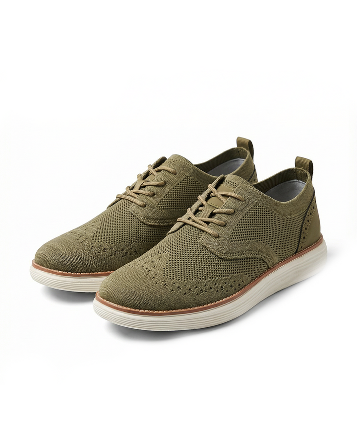 Men's hybrid dress sneakers with wingtip design and breathable knit upper, perfect for business casual.