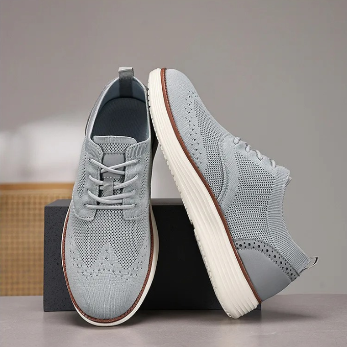 Detail shot of the knit upper on a men's hybrid dress sneaker, showing its flexible and modern texture.