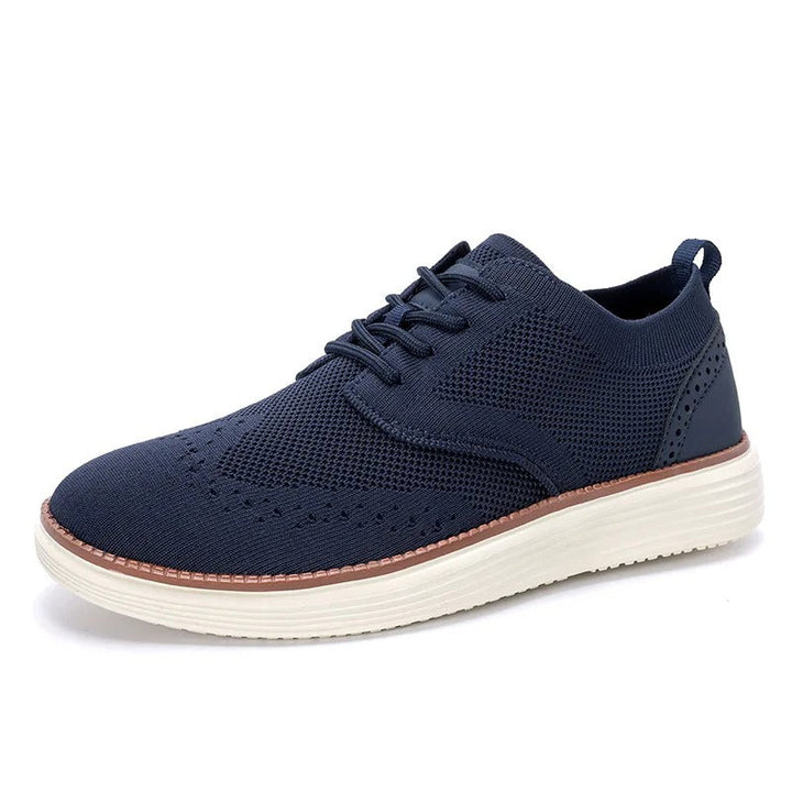Men's hybrid dress sneakers from the top, displaying the full wingtip pattern and comfortable sole.